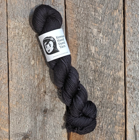 Black Bluefaced Leicester wool yarn on a wooden background